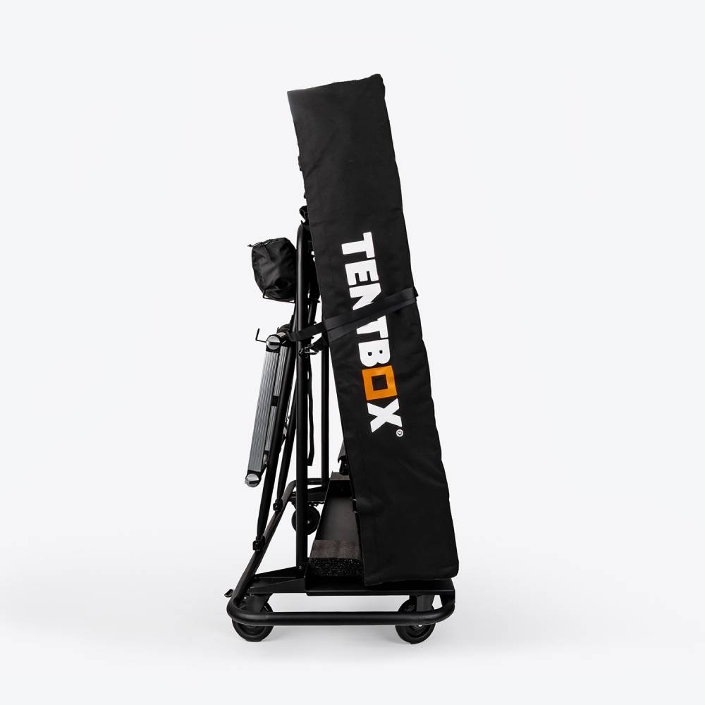 Black TentBox Storage Trolley, folded flat for transport, with white and orange logo.