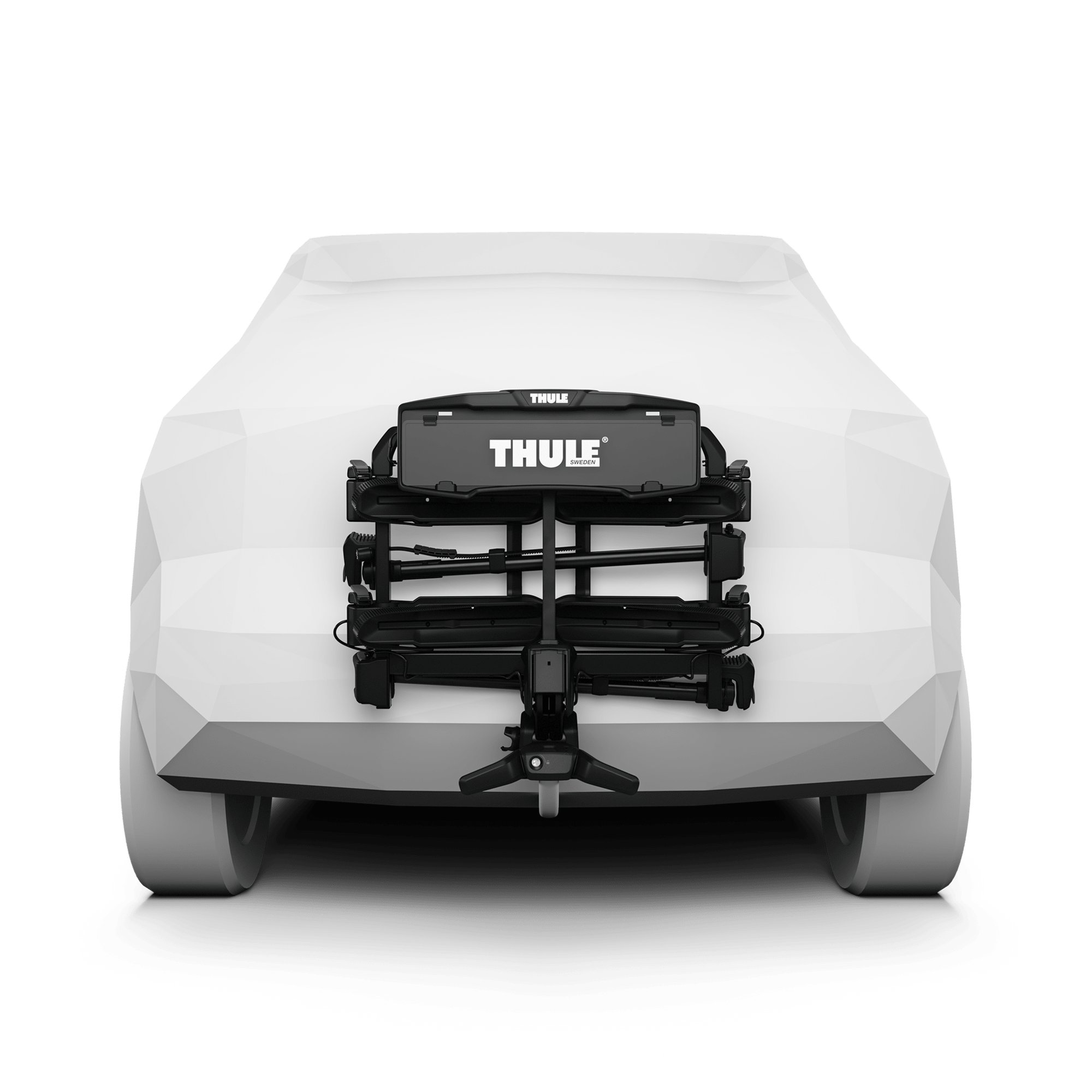 Black Thule OutPace 2-bike towbar rack on a white car, showing its compact, aerodynamic design.