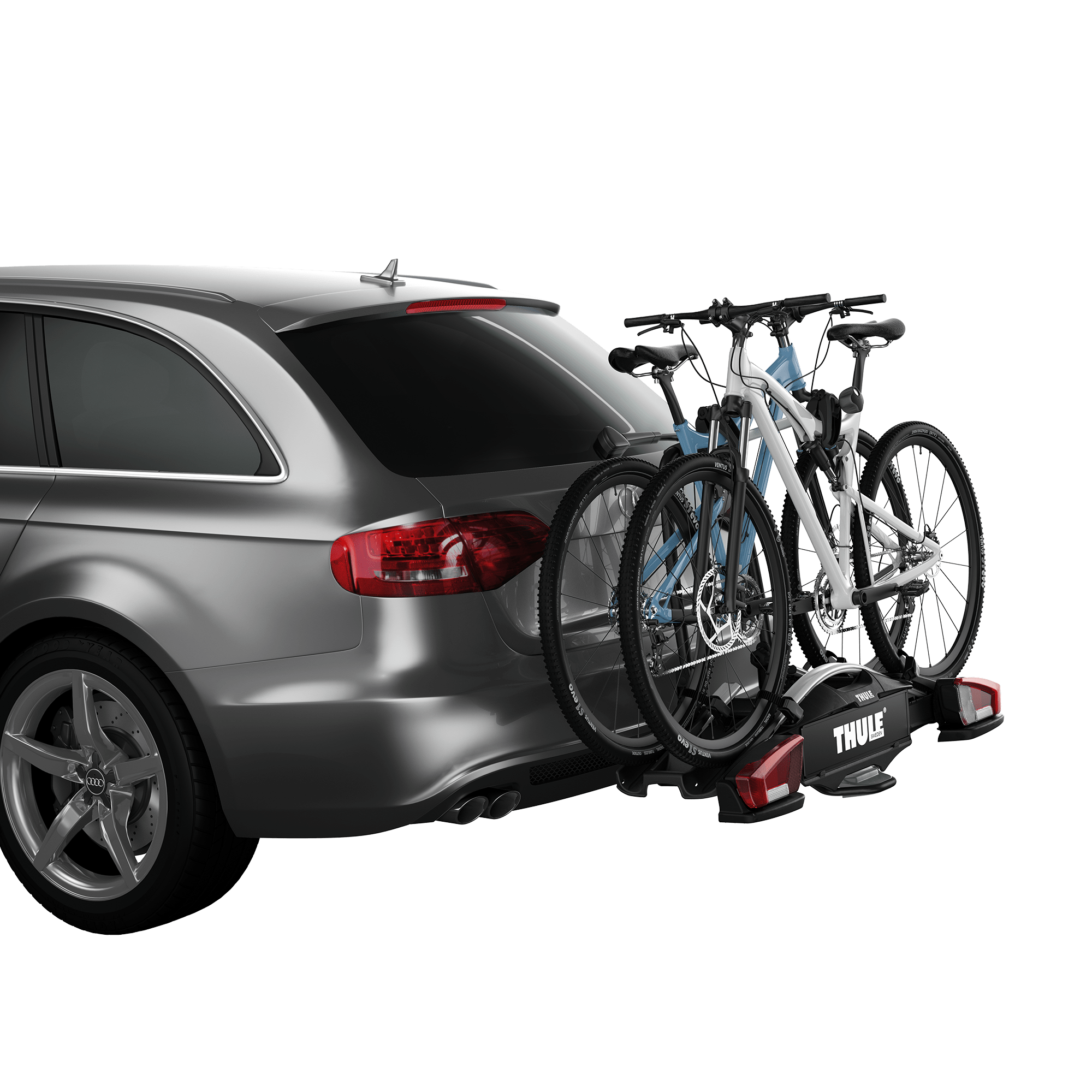 Thule VeloCompact 2 black towbar bike rack carrying two bikes on a grey car.