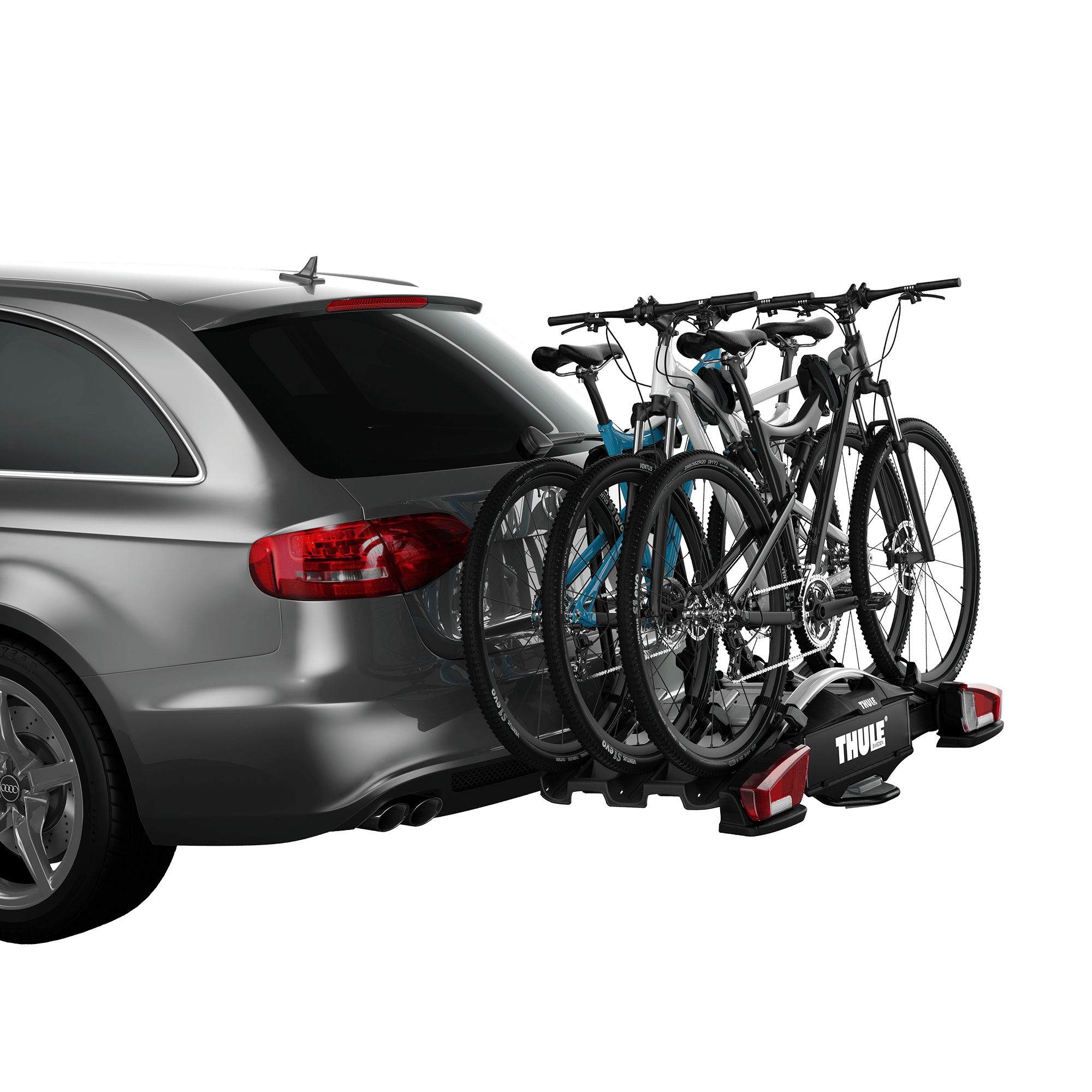 Gray Thule VeloCompact 3 towbar bike rack carrying three bikes on a gray car.