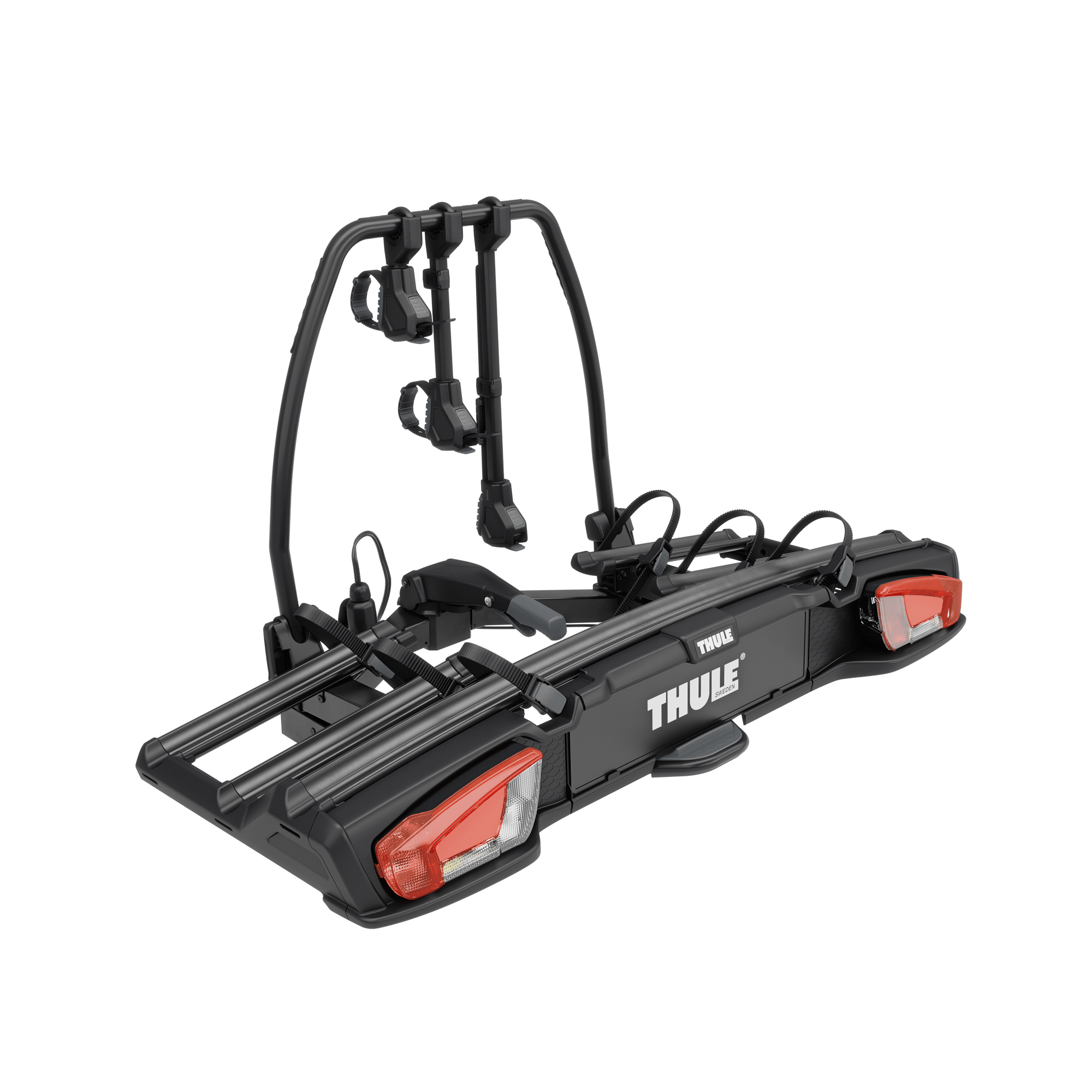 Thule VeloSpace 3 black towbar-mounted bike rack for 3 bikes, with red taillights and secure bike mounts.