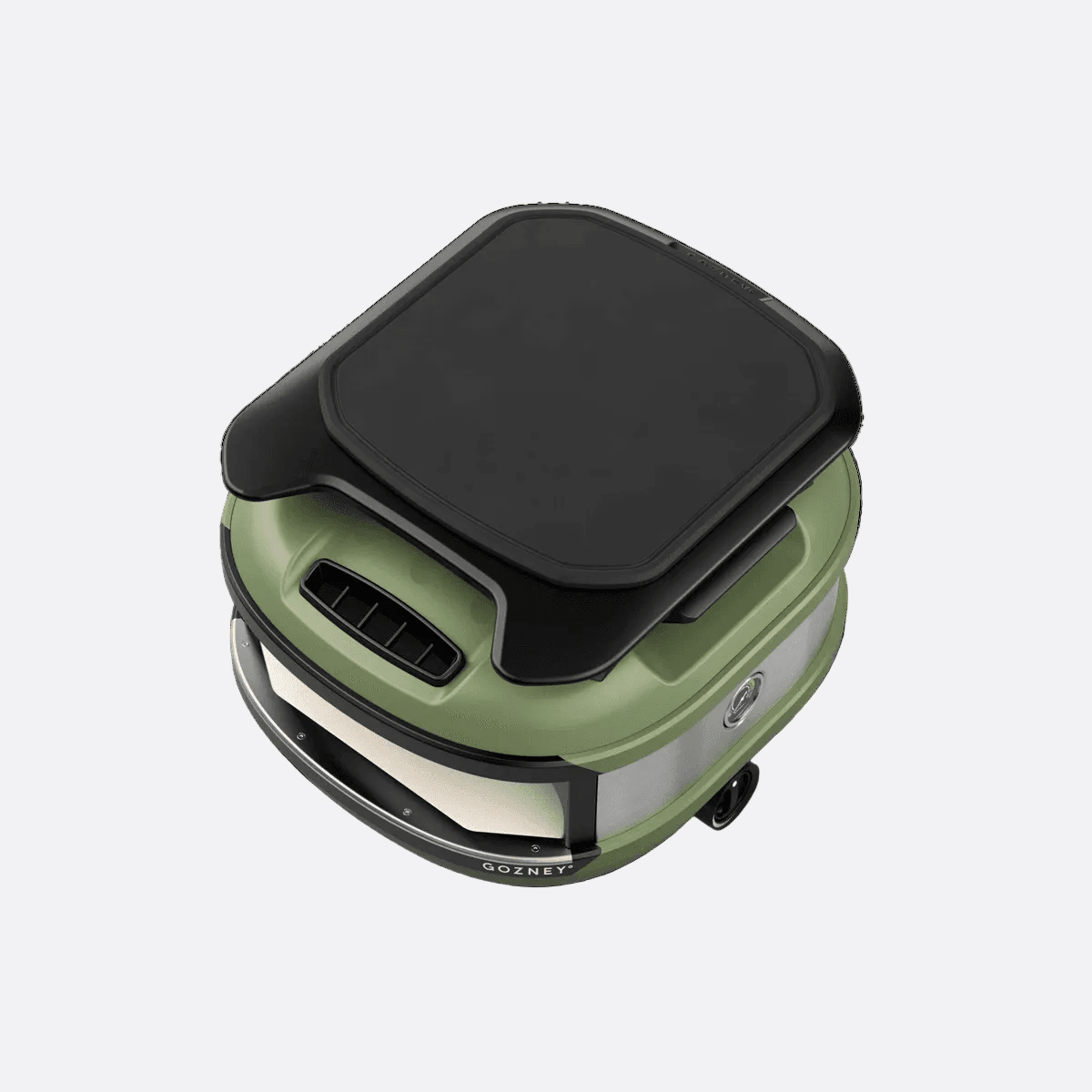 Tread Roof Rack with black cutting board on a green Gozney oven, showing its lightweight aluminum base.