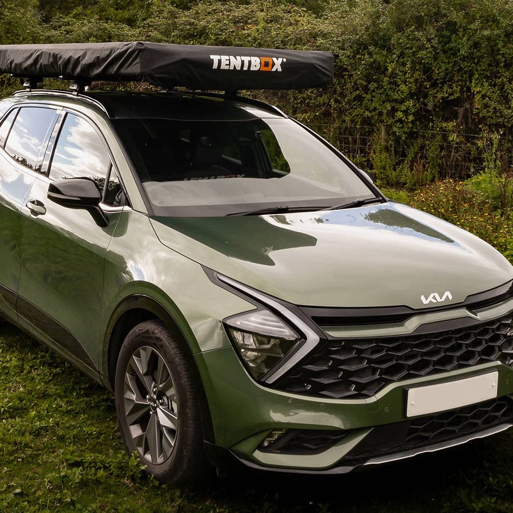 Black TentBox Cargo protective cover on a green SUV, offering all-year weather protection.