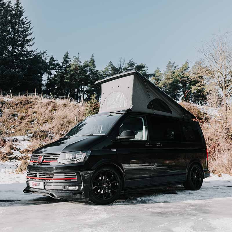 Black VW T6 sports van in the snow