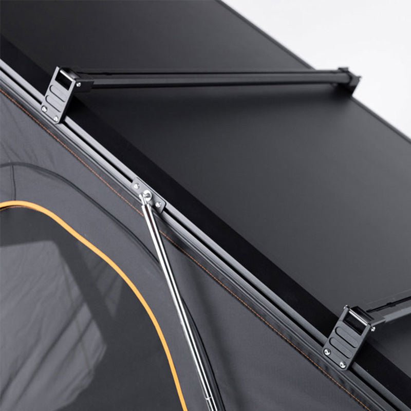 Black TentBox Cargo 2.0 roof bars with a low-profile design, mounted on a dark grey tent with orange trim.