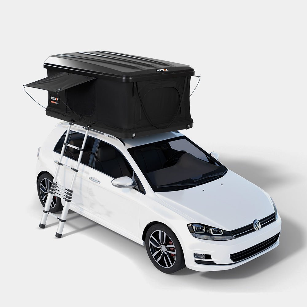 TentBox Classic 2.0 rooftop tent in matte black with an angular ABS shell, mounted on a white car with a ladder extended.