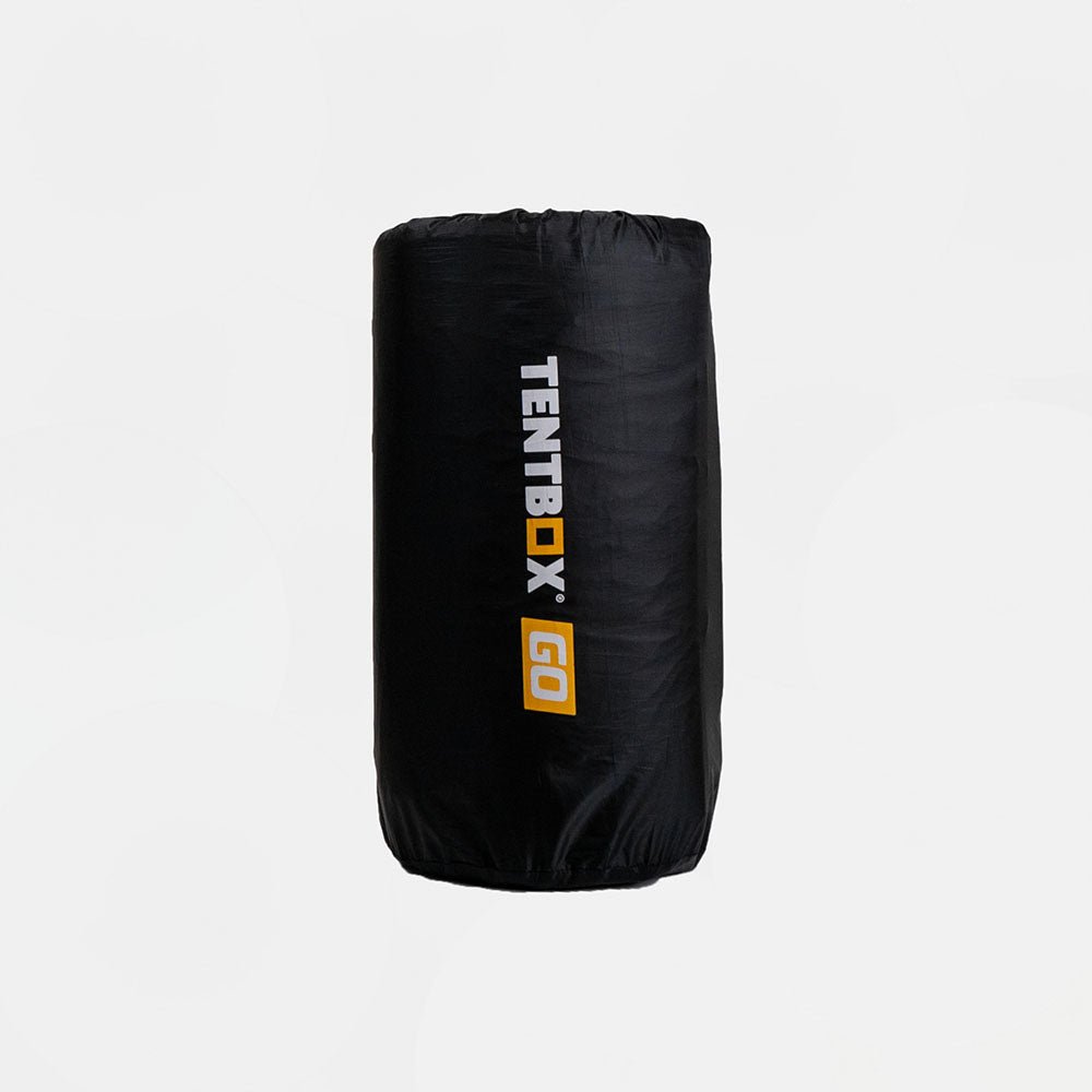 Black TentBox Go self-inflating mattress rolled in its storage bag with white and orange logo.