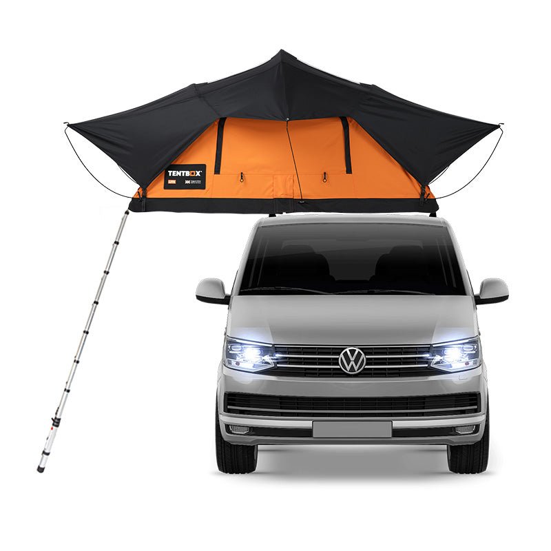 TentBox Lite 2.0 rooftop tent in black and orange, open on a silver Volkswagen van.