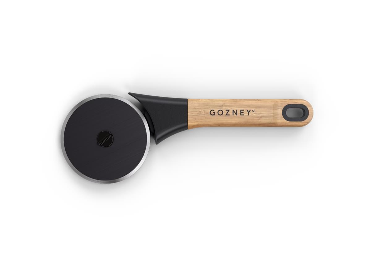 Gozney pizza cutter with a black blade, natural wood handle, and black grip.