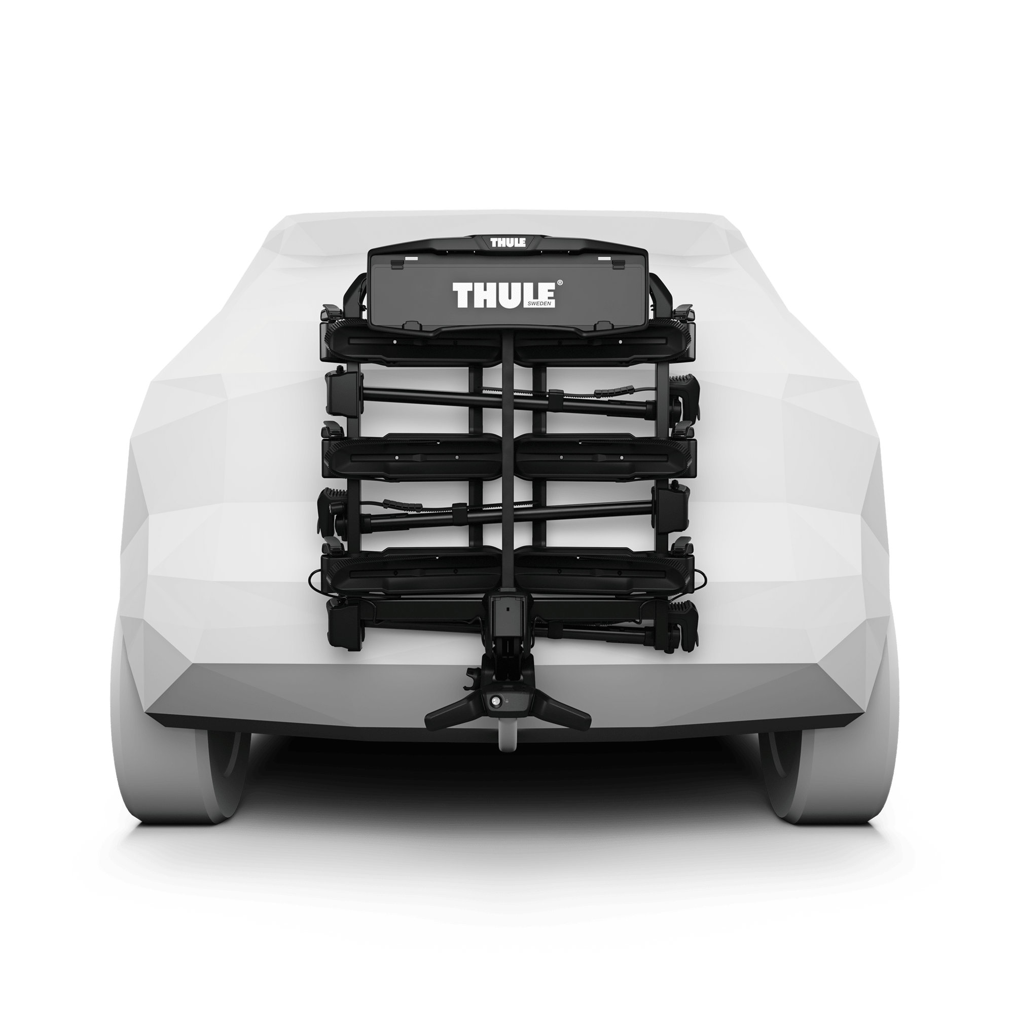Black Thule OutPace 3-bike rack mounted on the rear of a white car, featuring a compact platform design.