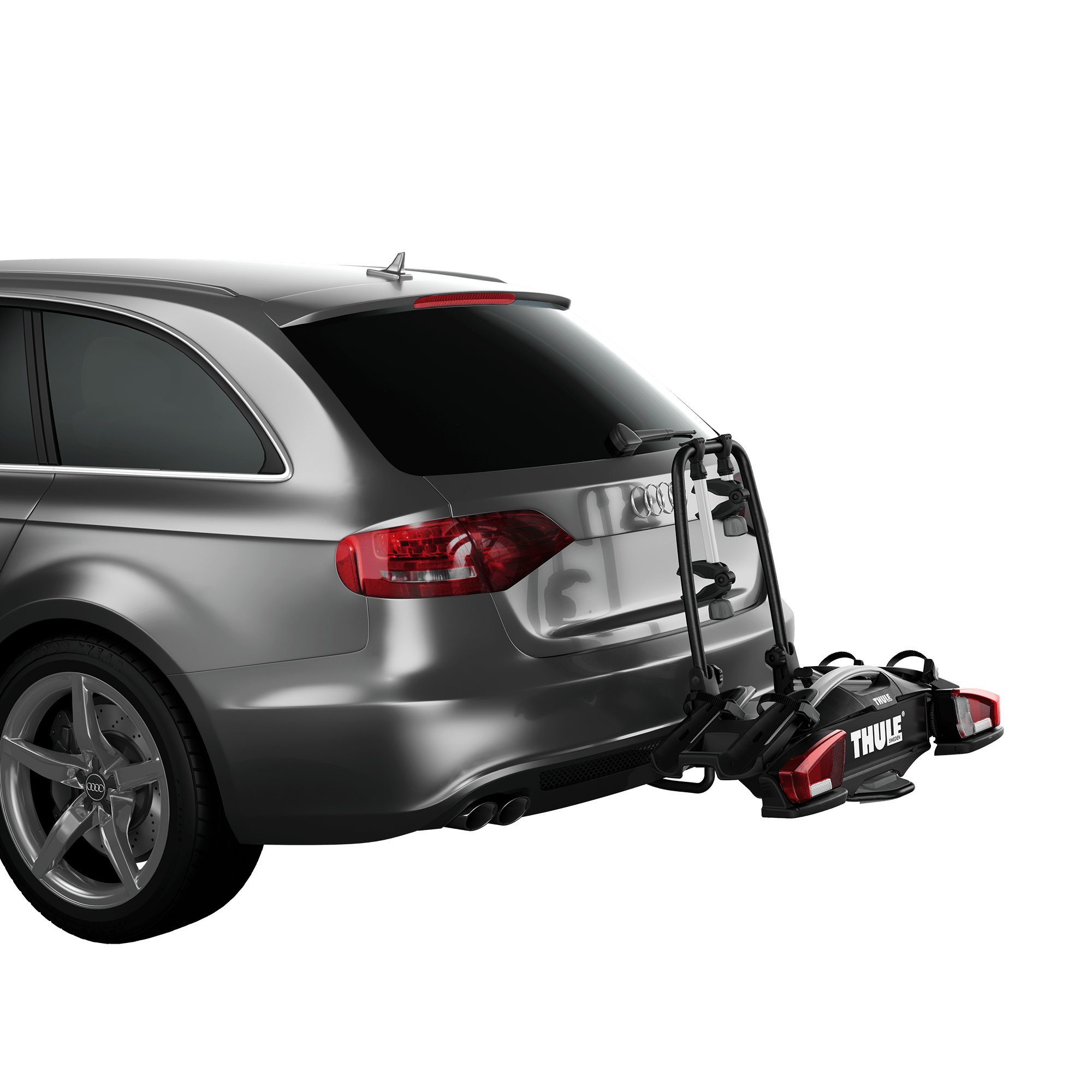 Thule VeloCompact 2 bike rack, black and silver, mounted on a gray car's towbar, ready for two bikes.