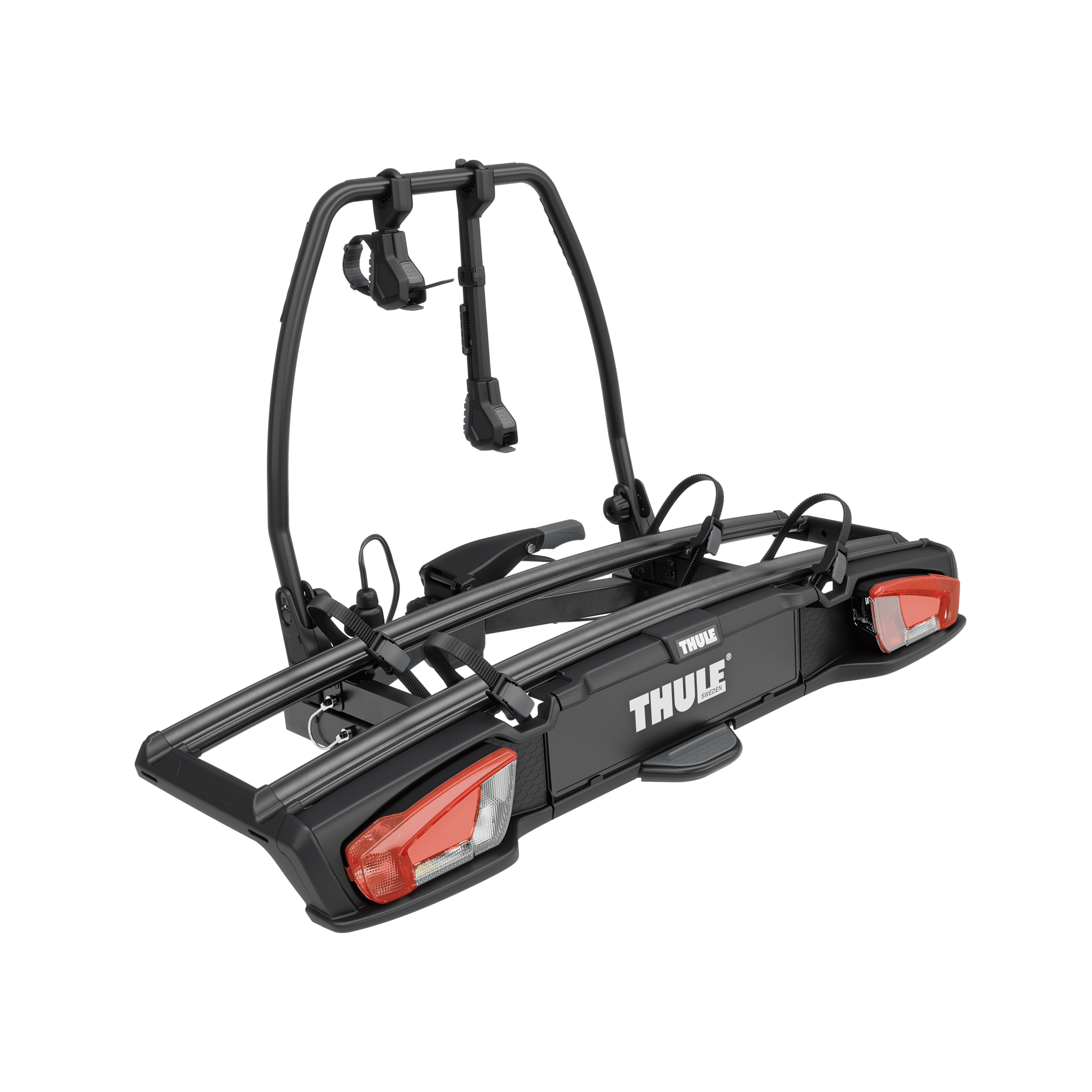 Black Thule VeloSpace 3 towbar bike rack for 2 bikes, with red taillights and secure straps.