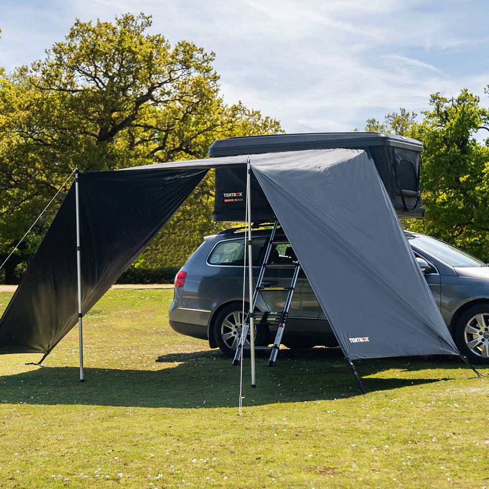 Dark grey Classic Tunnel Awning attached to a car with a roof tent, providing shaded shelter.